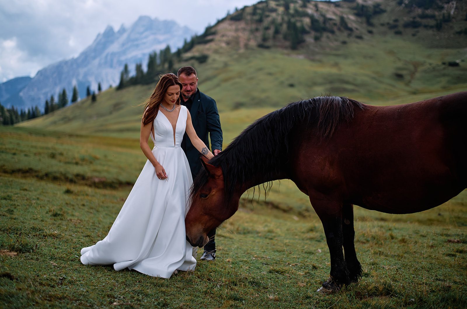 Couple and horses on the Prato Piazza plateau, Dolomites