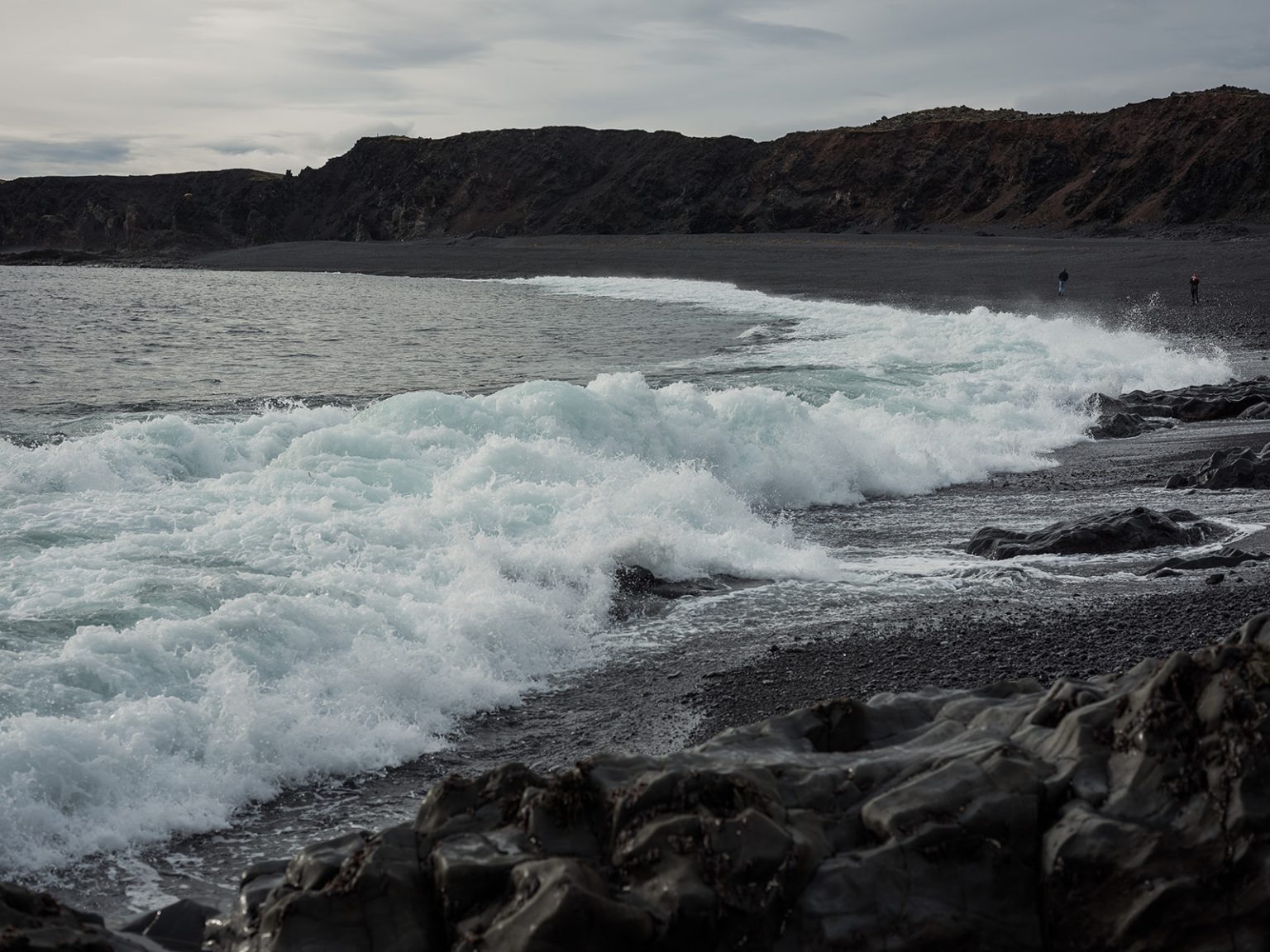 The couple on a dramatic sea cliff, Snæfellsnes, Iceland