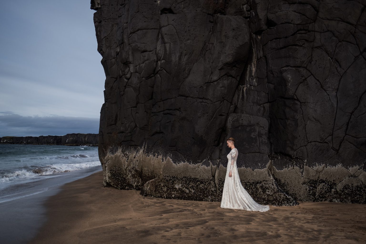 On the black beach below the cliffs, a Hótel Búðir wedding