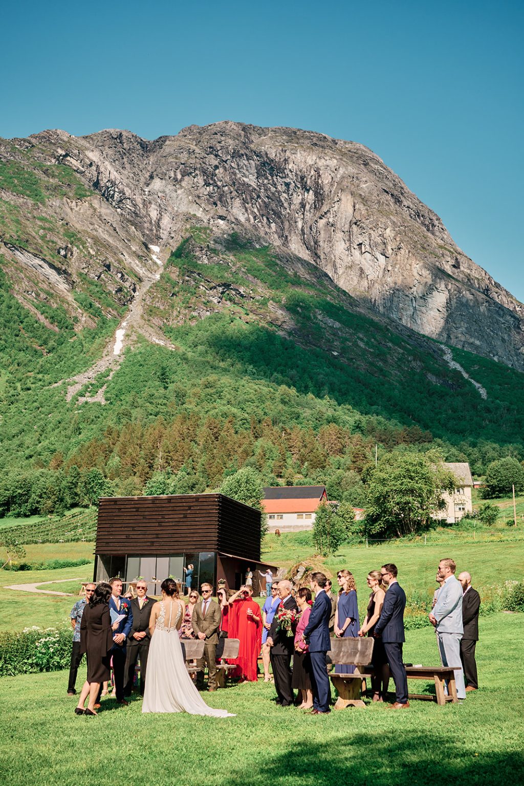 The wedding ceremony below the mountains at Juvet