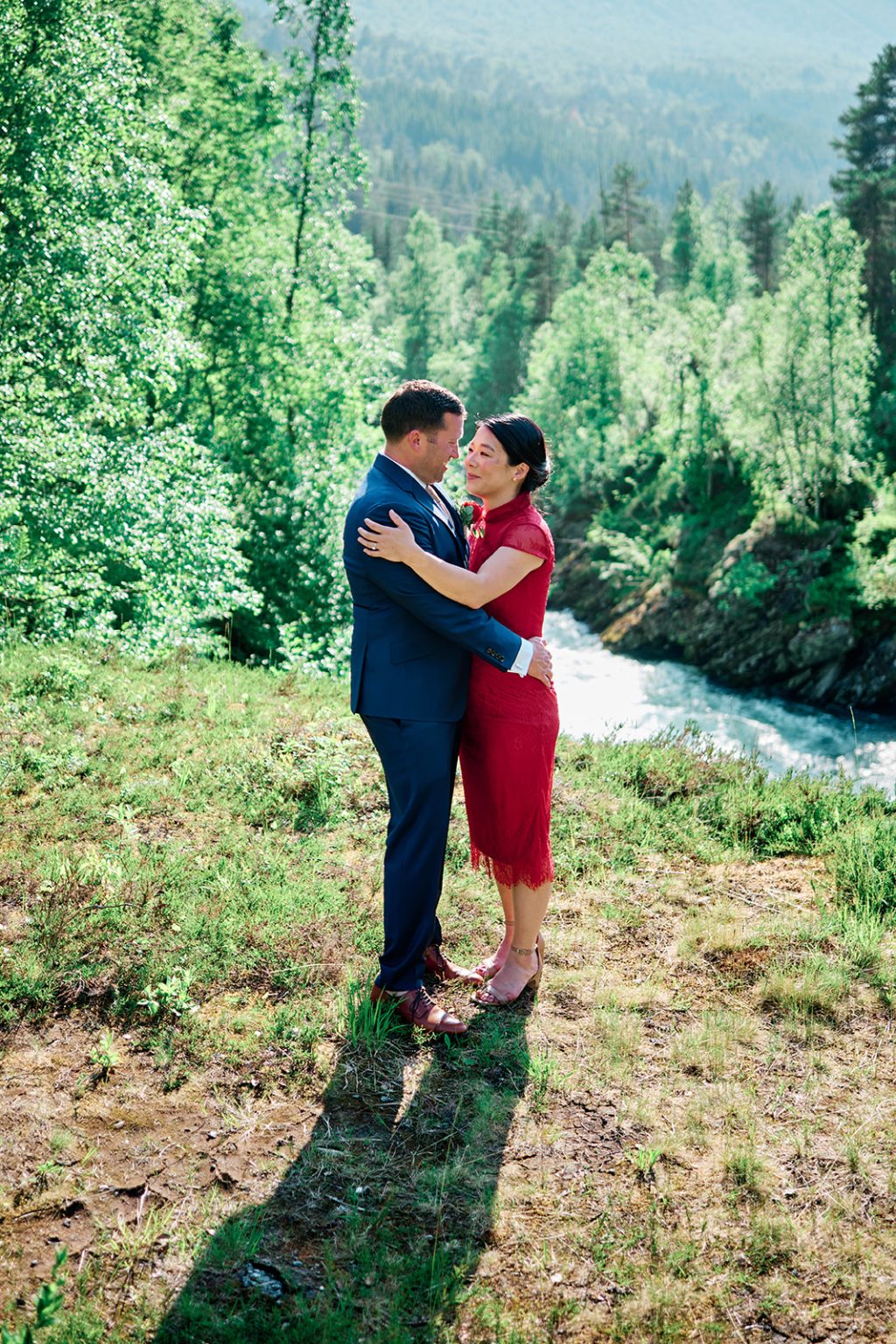 The bride in red by the river at Juvet