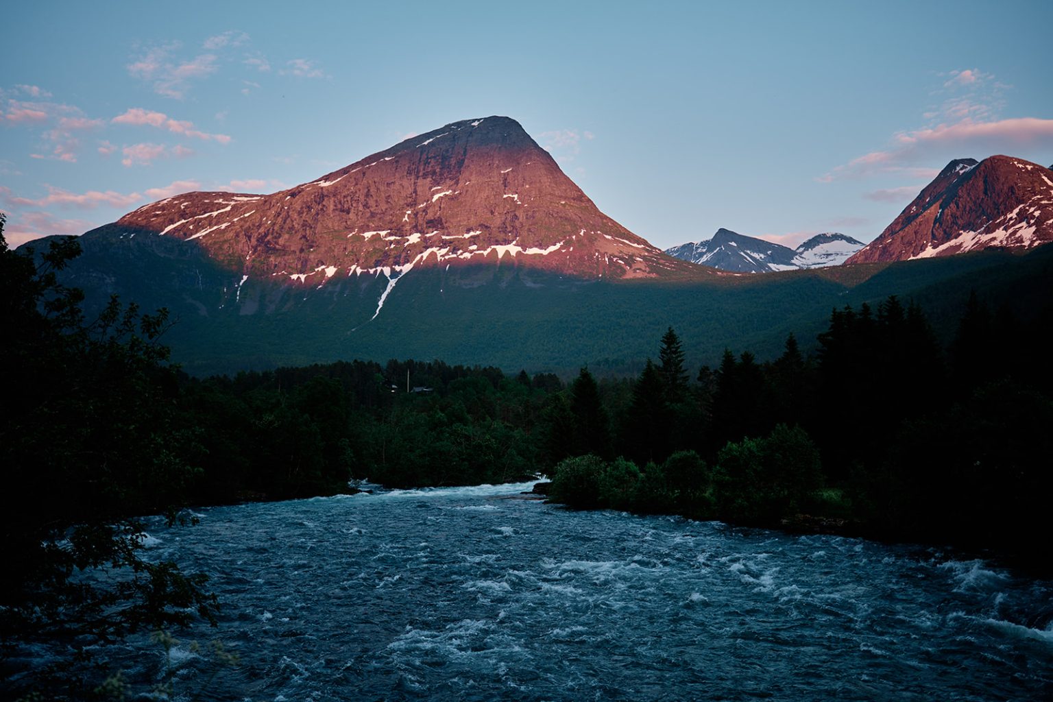 Dusk over the river and peaks in Valldal, Norway
