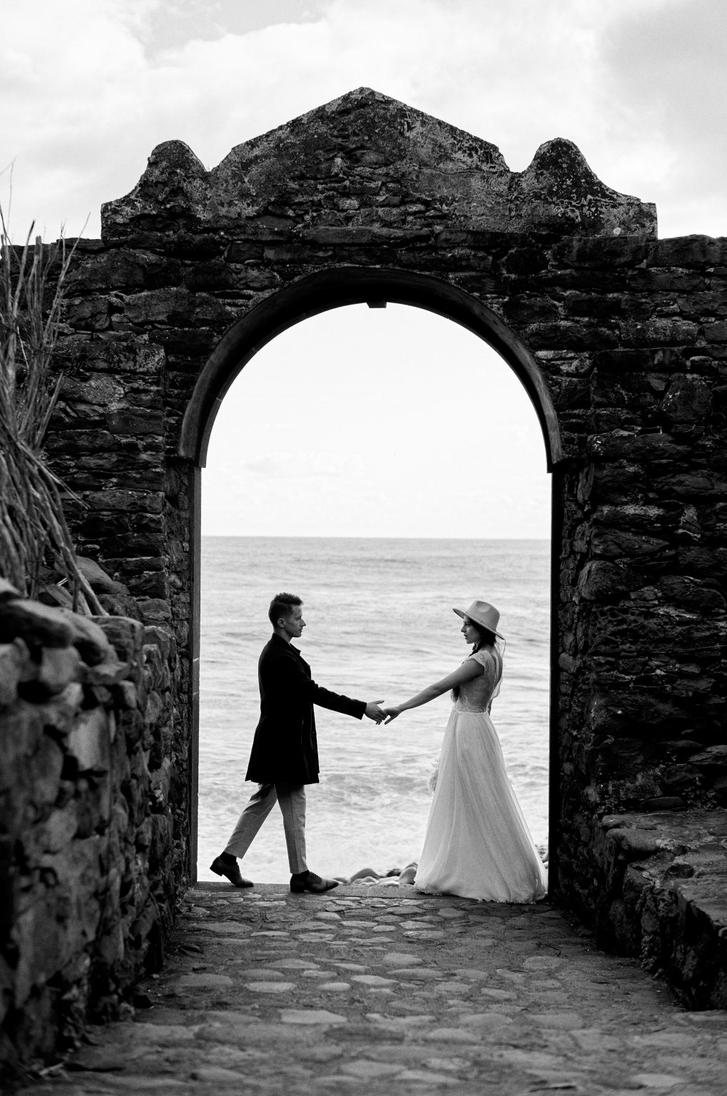 Couple framed by the arches of the Ruinas de Sao Jorge, Madeira engagement session