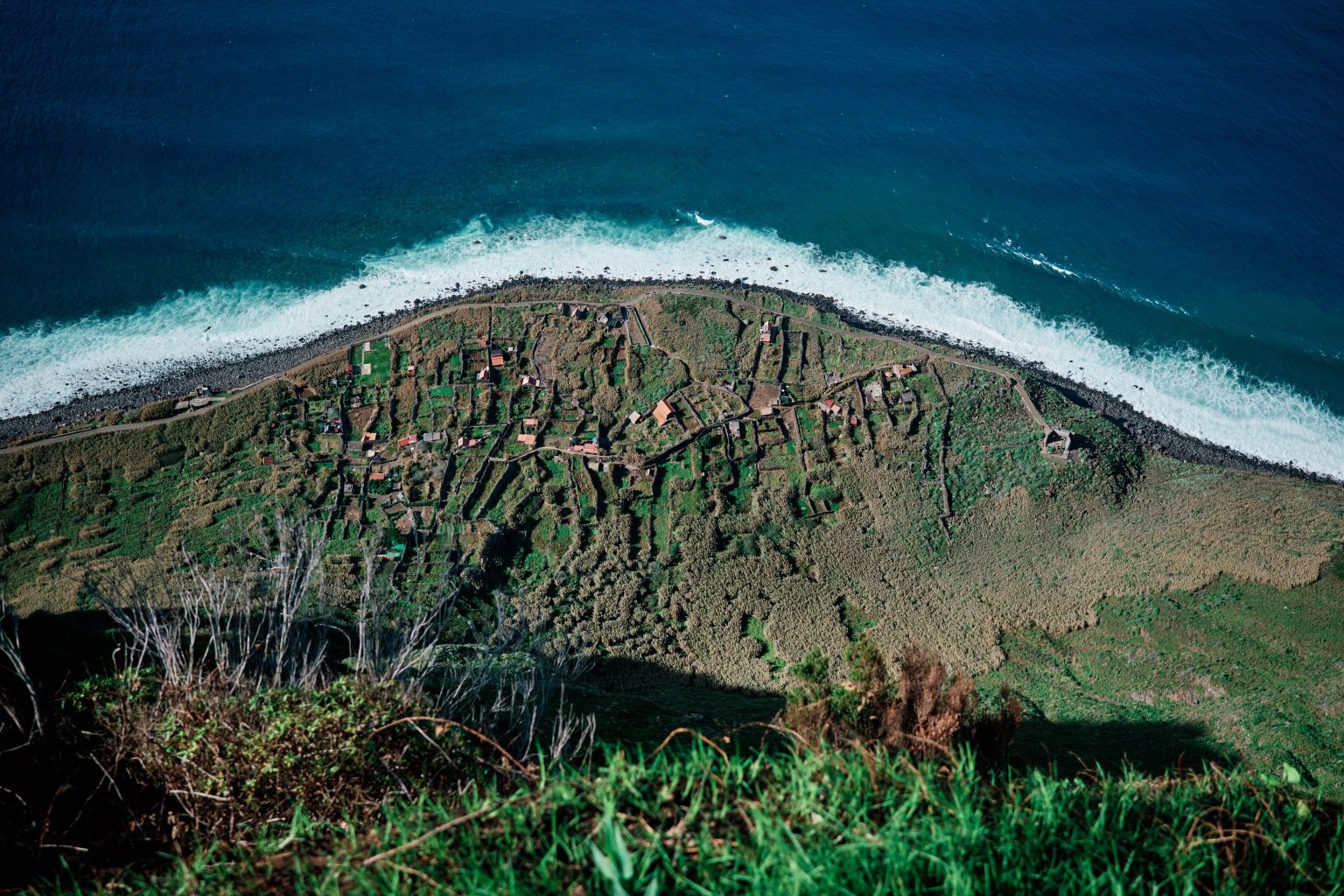 Green cliffs and surf at Achadas da Cruz, Madeira