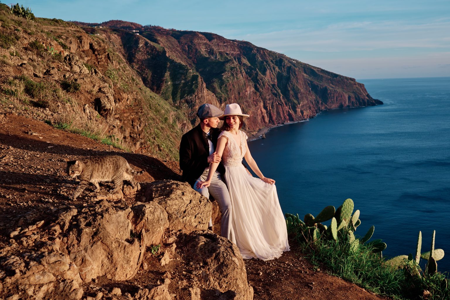 Couple on the cliffs at the Farol da Ponta do Pargo at golden hour, Madeira