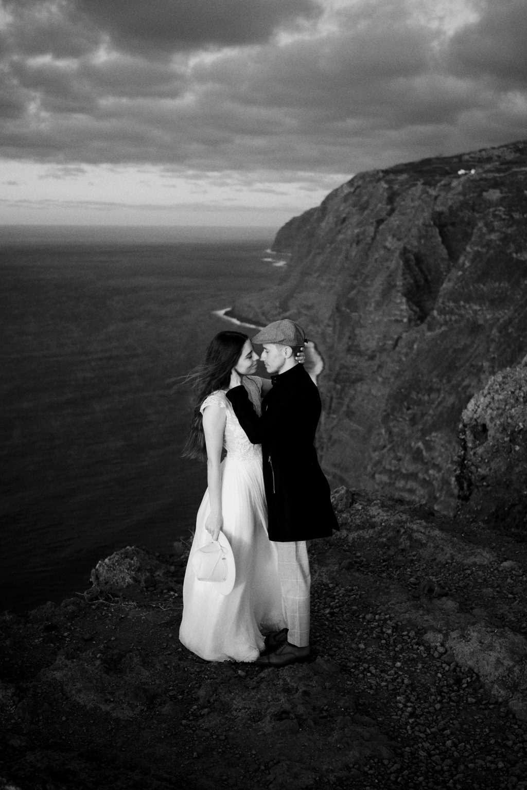 Couple at dusk at the Farol da Ponta do Pargo, black and white, Madeira