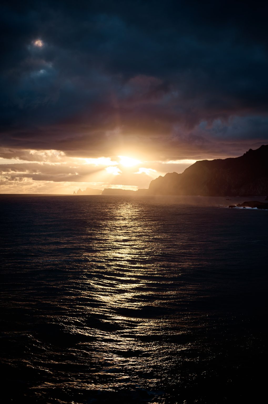 Sunrise light over the sea near the Miradouro do Guindaste, Madeira