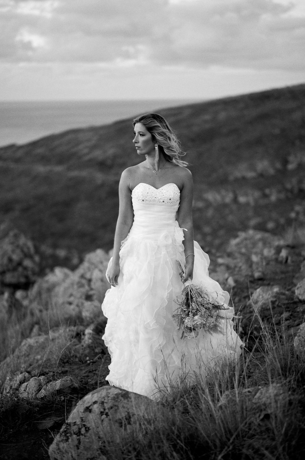 Bride in the wind on the cliffs at sunrise, Ponta de Sao Lourenco, Madeira