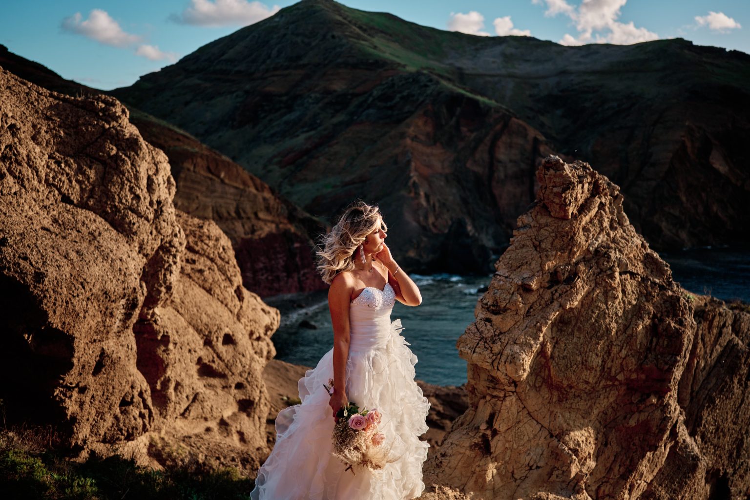 Bride among the red rock formations of Ponta de Sao Lourenco, Madeira