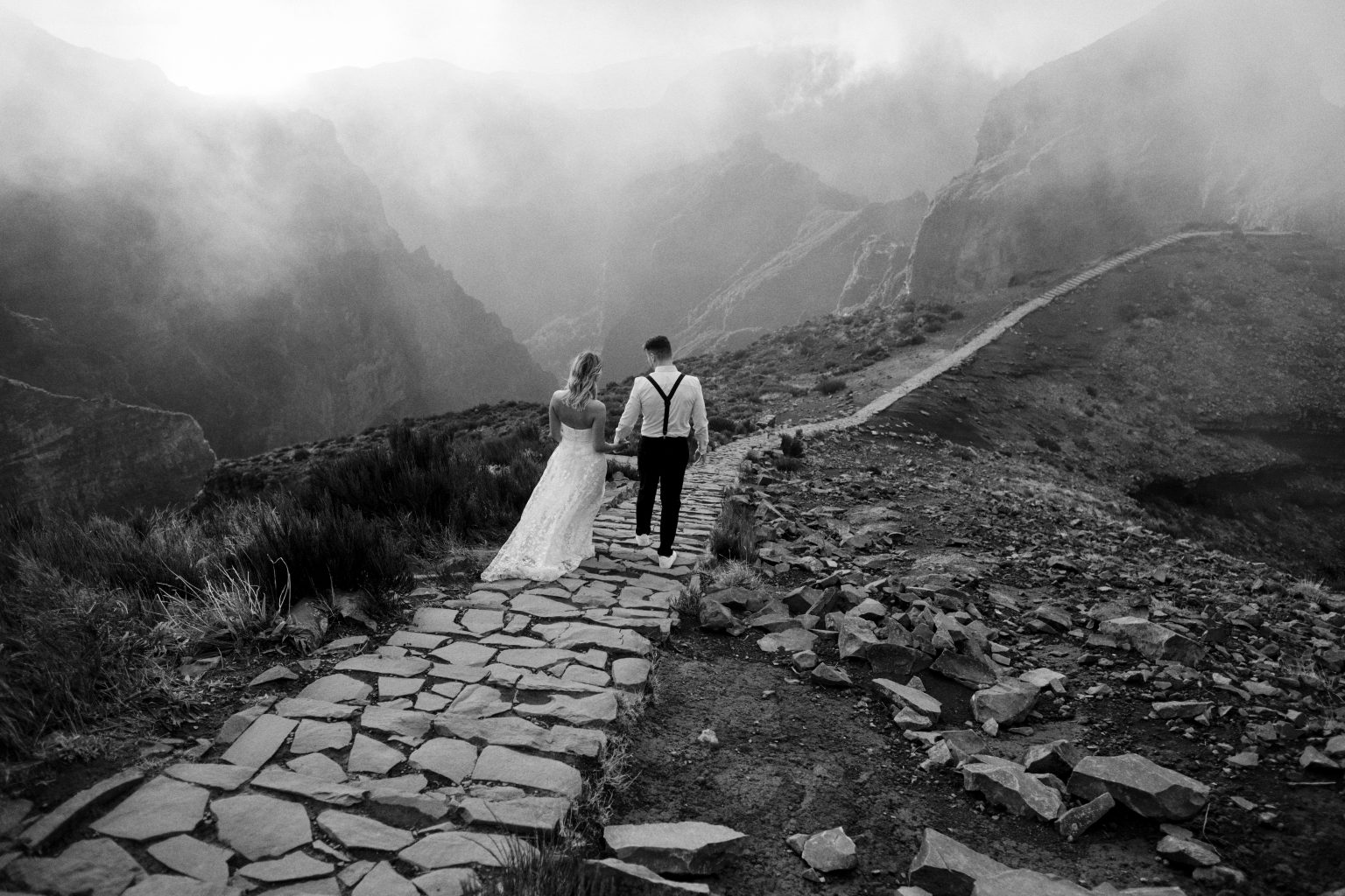 Couple on a foggy mountain path in black and white, Madeira