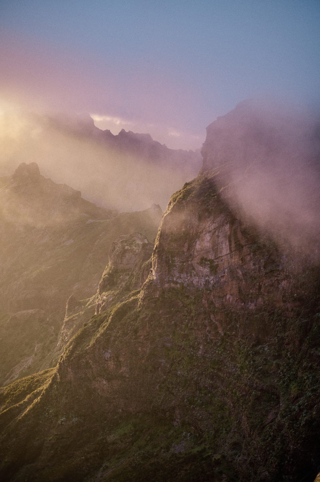 Couple on the peak in dramatic sunset light, Pico do Arieiro, Madeira