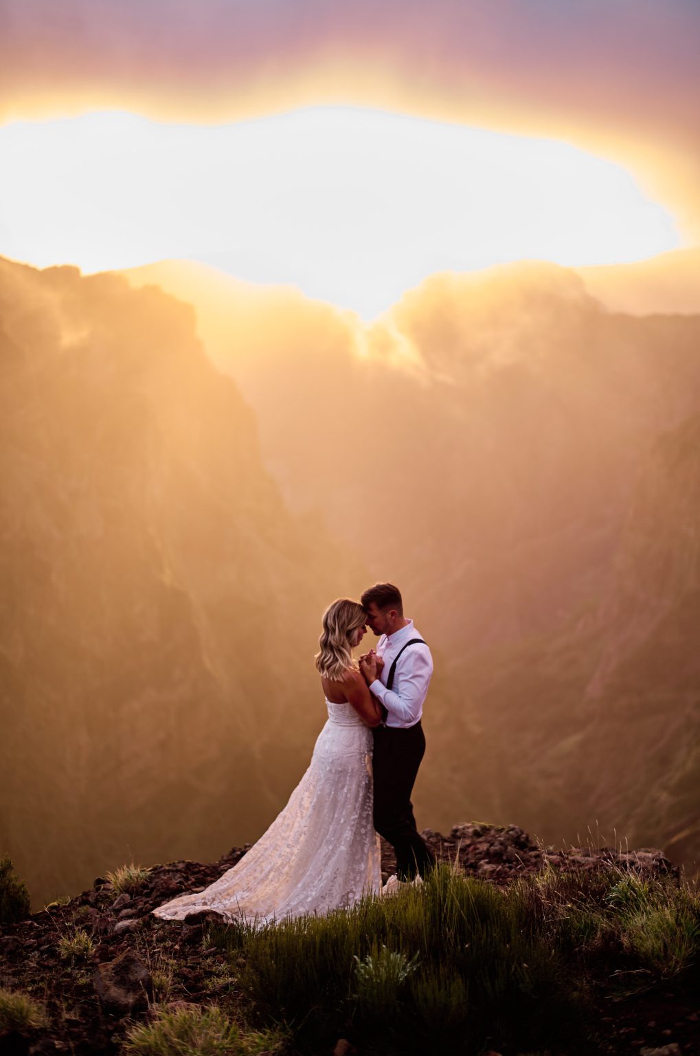 Couple close together in deep pink sunset light, Pico do Arieiro, Madeira