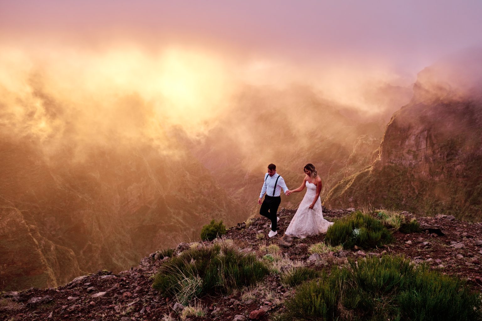 Couple on Pico do Arieiro at a pink and orange sunset, Madeira