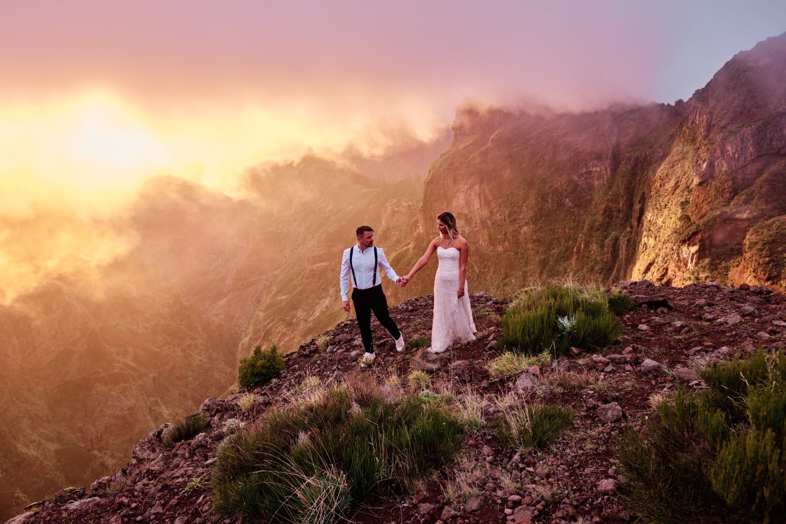Couple on the ridge above a sea of cloud at sunset, Pico do Arieiro, Madeira