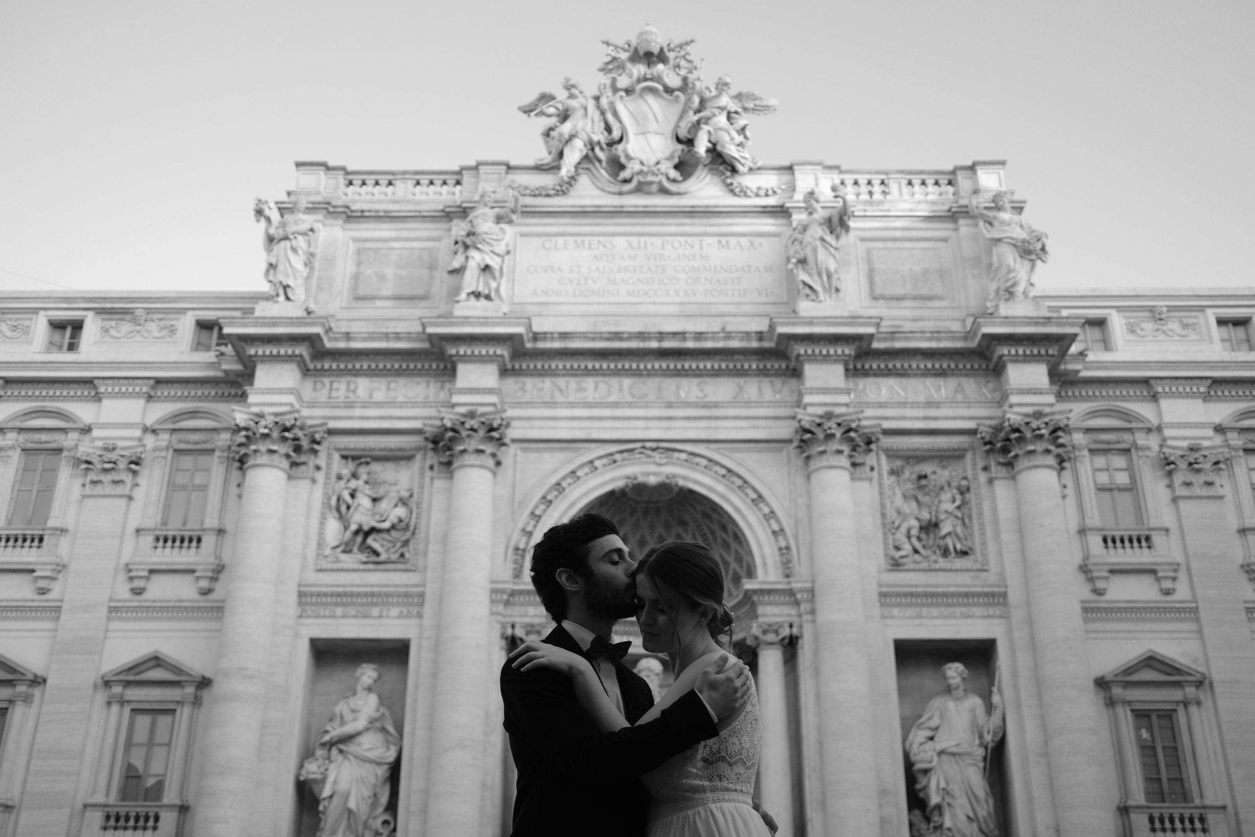 A couple in the empty streets of Rome at sunrise