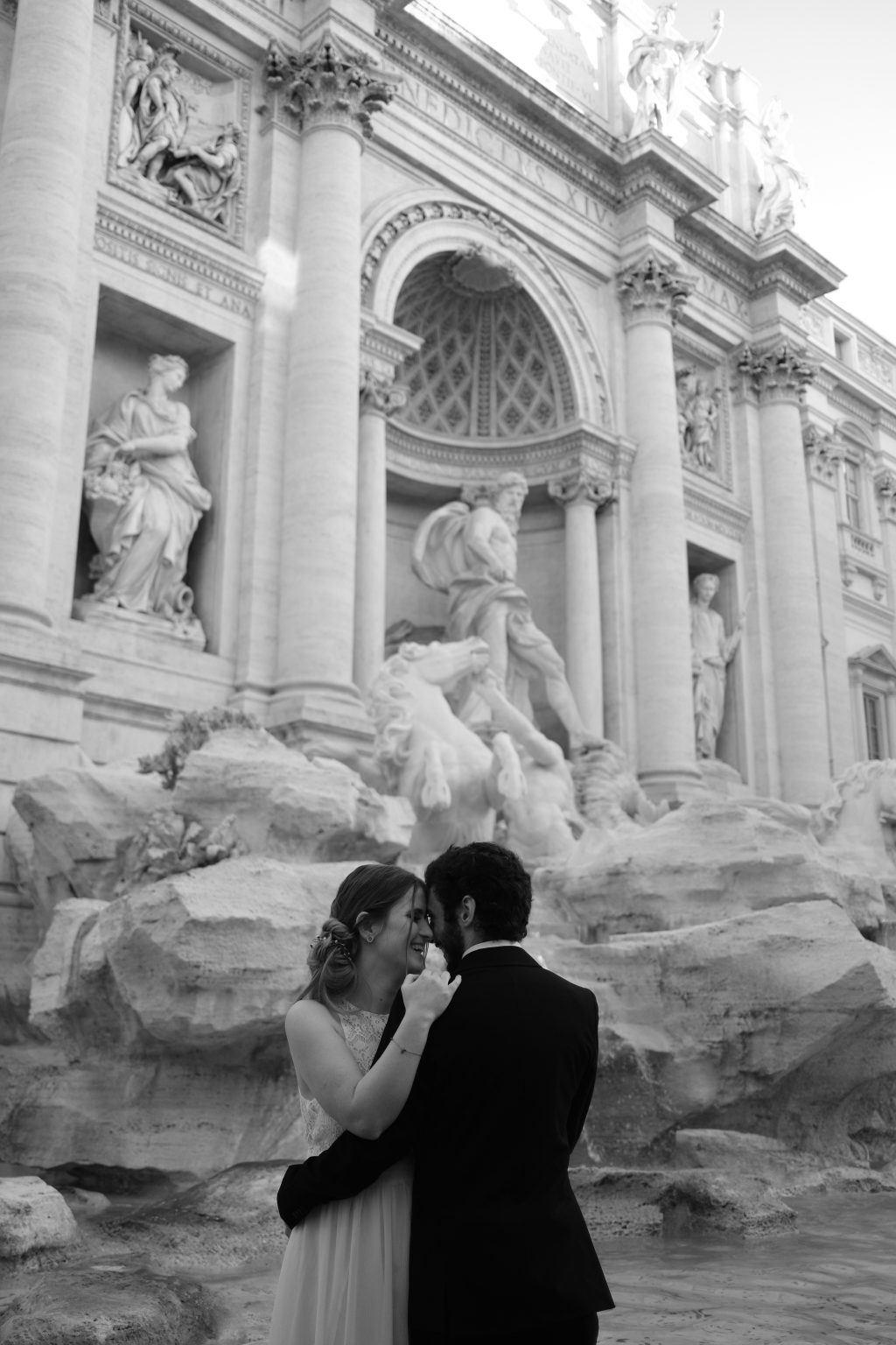 A quiet kiss at the Trevi Fountain before the crowds arrive