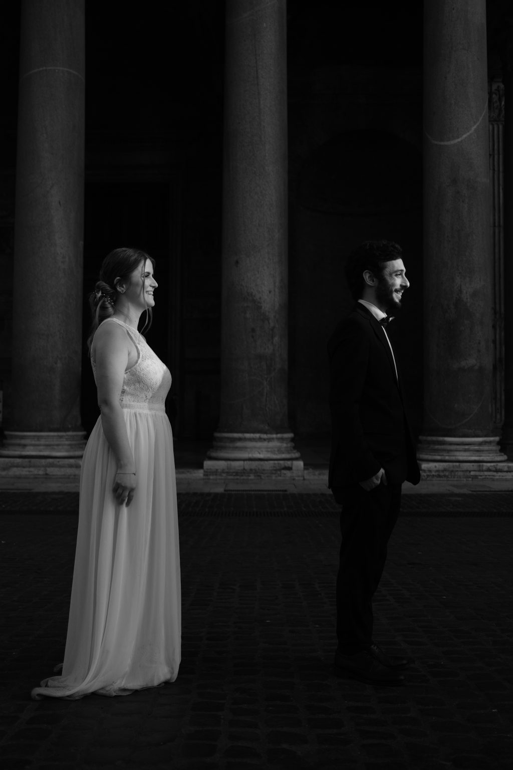 Rozina and Salvatore laughing face to face in black and white