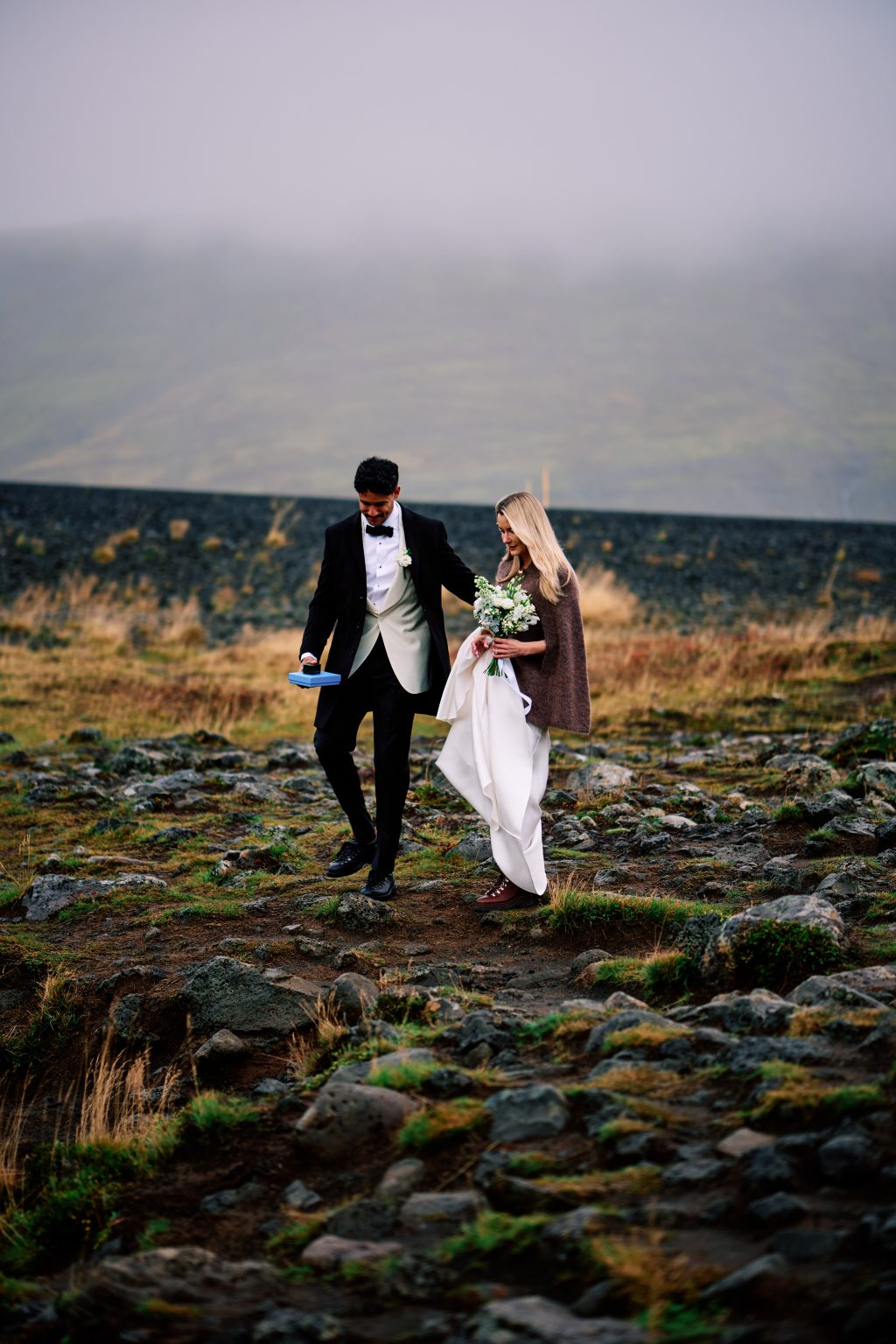 Daniel carrying the bouquet across the lava field at Þórufoss