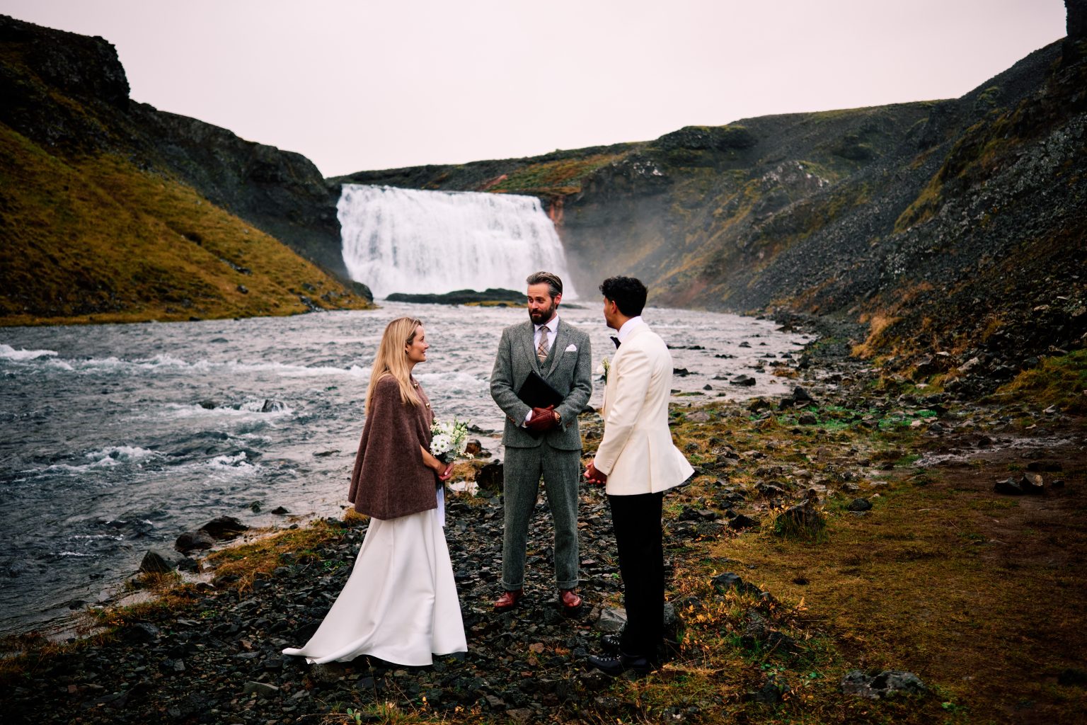 Elopement ceremony beside Þórufoss waterfall in the rain