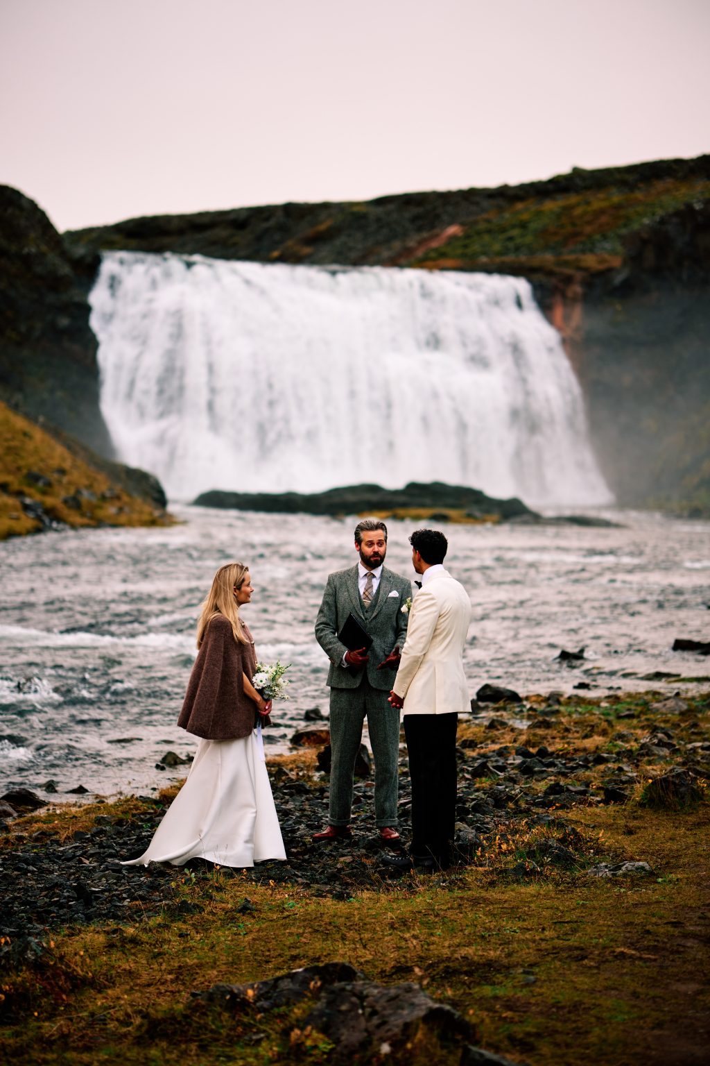 Lindsey and Daniel exchanging vows at Þórufoss with their celebrant