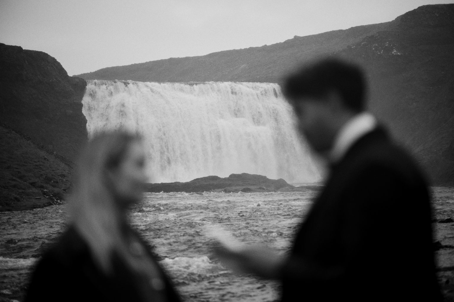 Þórufoss waterfall behind the groom during the ceremony