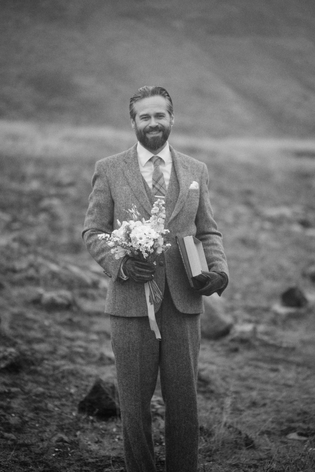 Wedding bouquet and ceremony book in the rain at Þórufoss