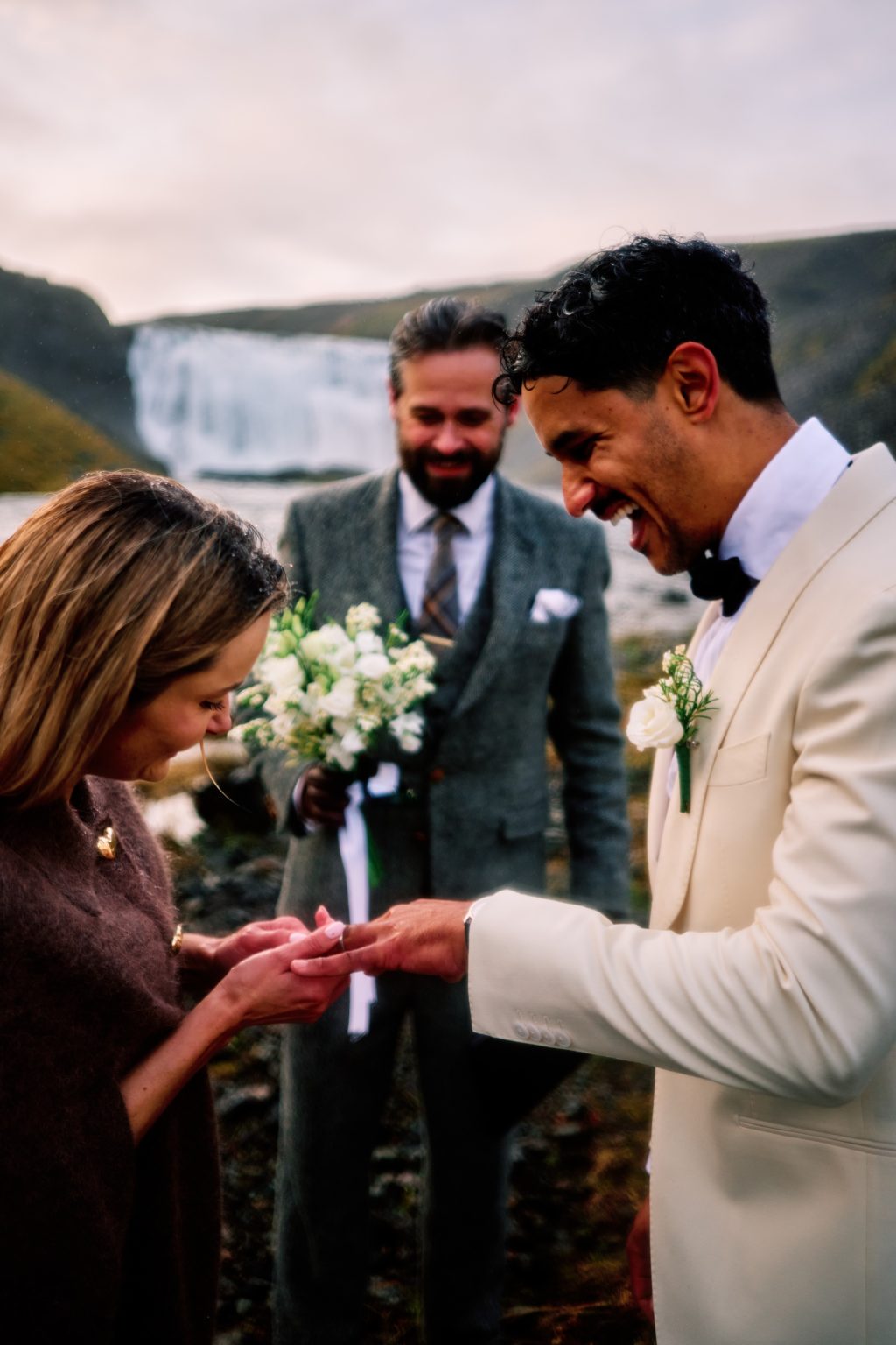Exchanging rings at a rainy Þórufoss elopement ceremony