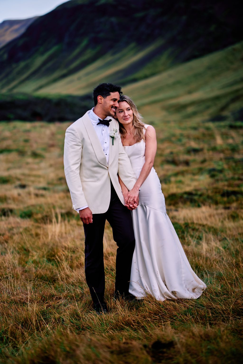 Bride and groom in the golden grass at Eyrarbakki