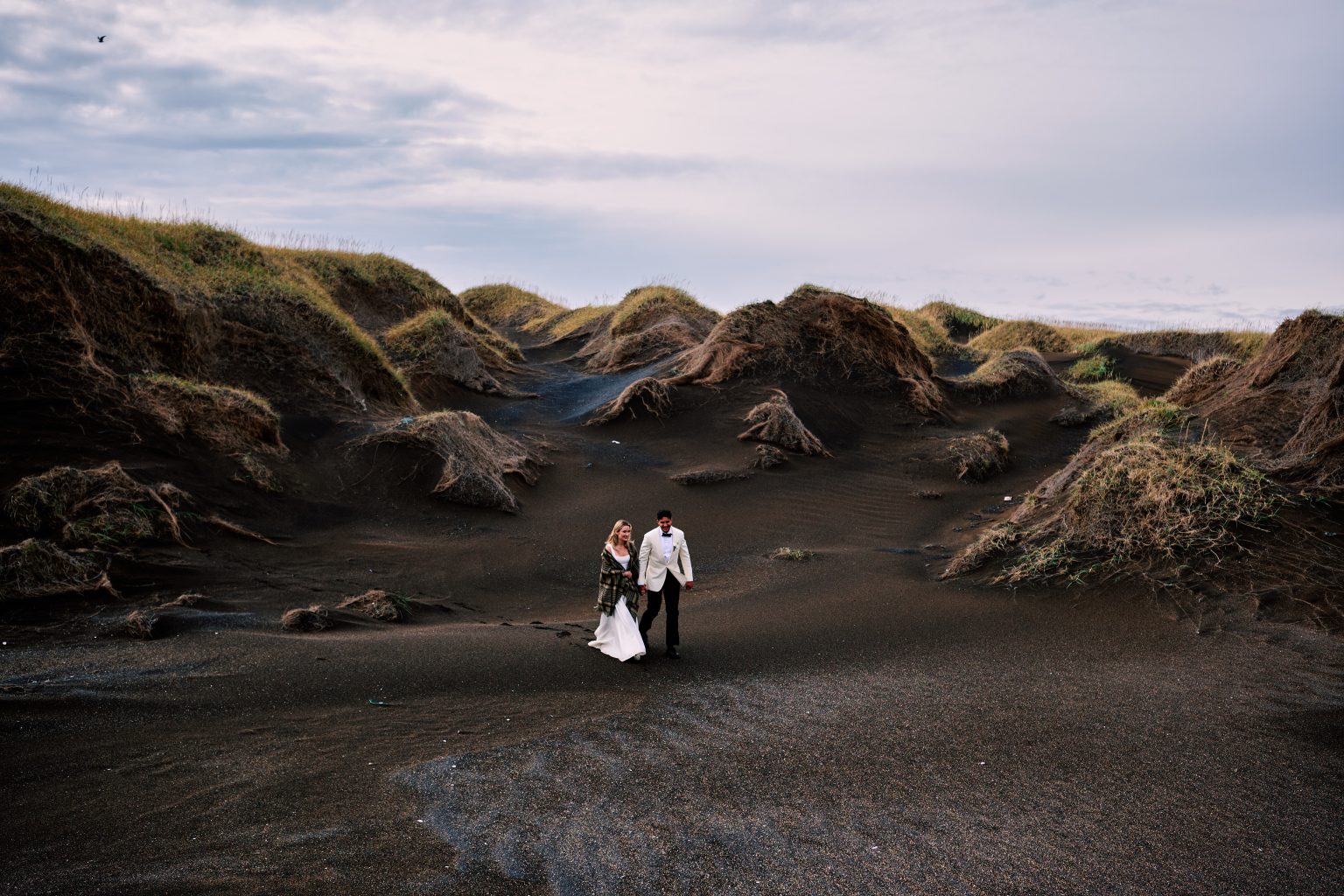 Lindsey and Daniel walking the black sand dunes near Eyrarbakki