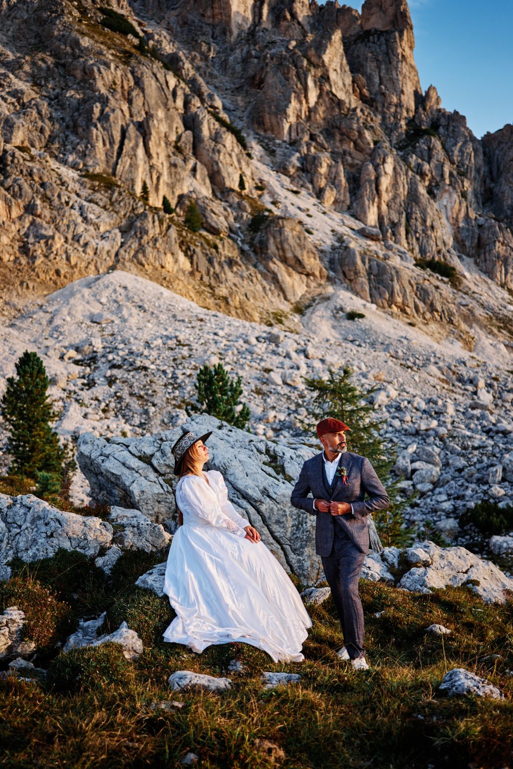 The couple on the ridge as the sky lightens over Passo Giau