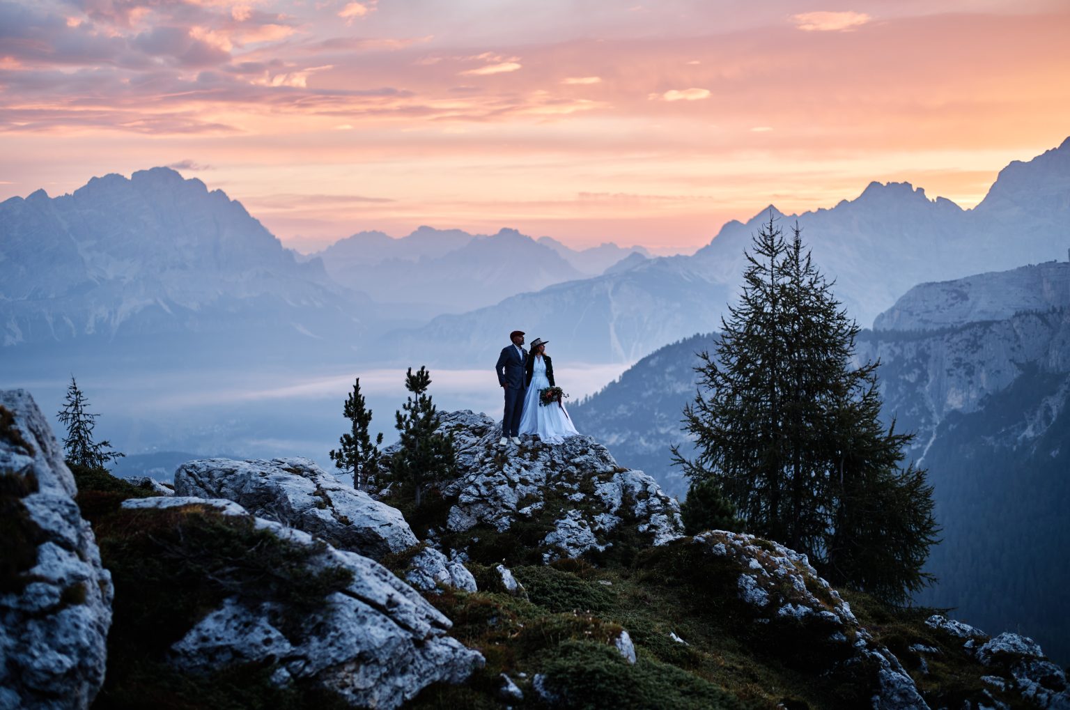 Couple eloping at Passo Giau as the sky turns pink over the Dolomites