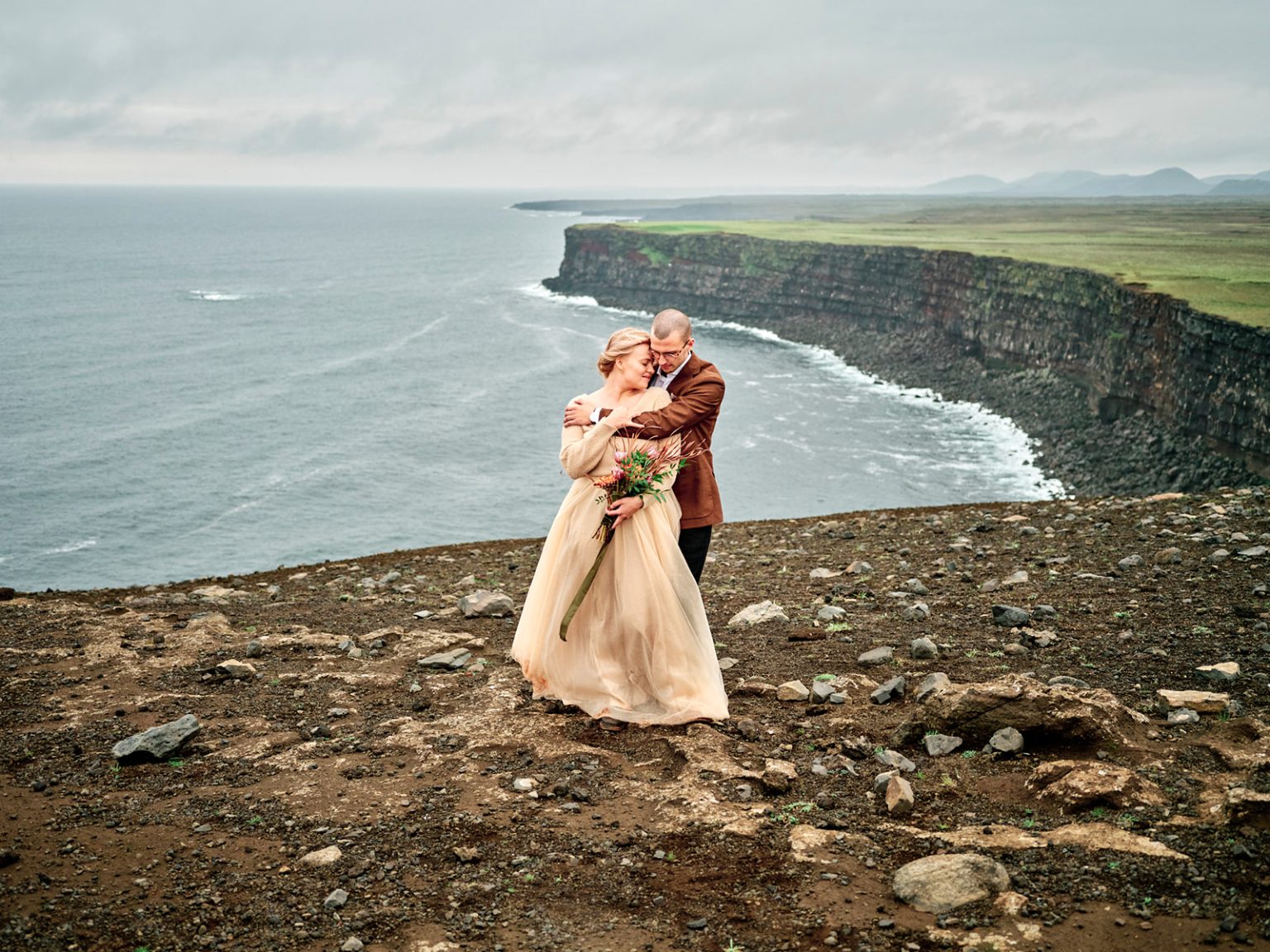 An embrace on the cliff above the Atlantic, a Reykjanes engagement