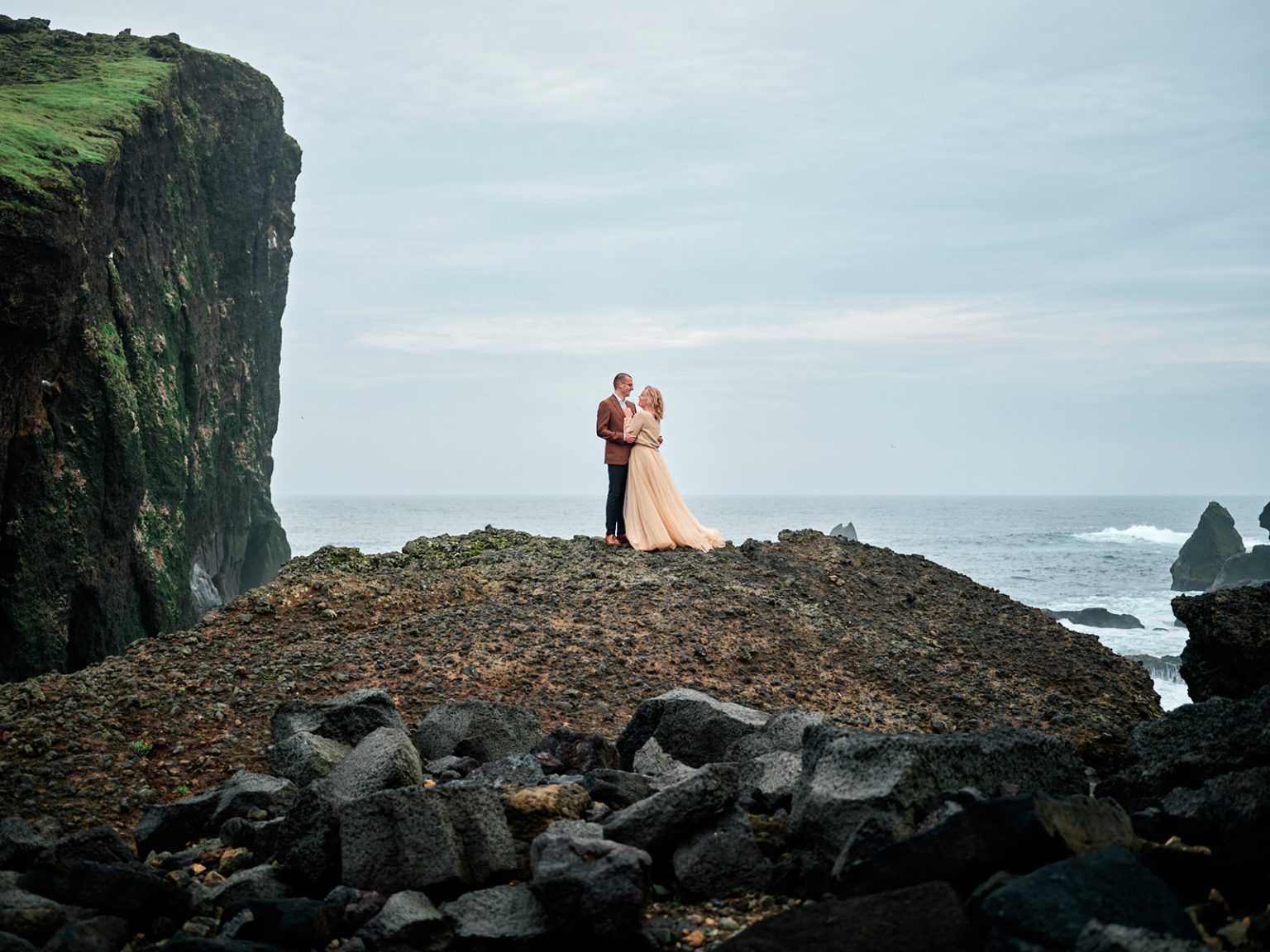 The couple above the sea stacks at Reykjanes, Iceland