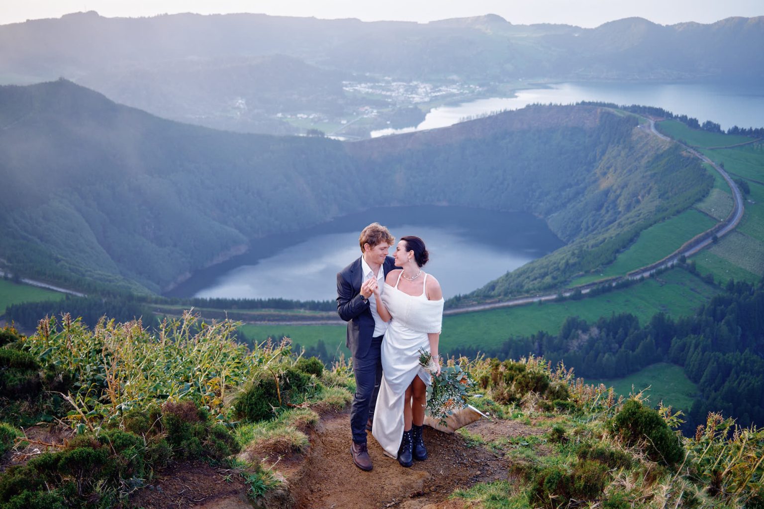 Bride and groom embracing at sunset on São Miguel