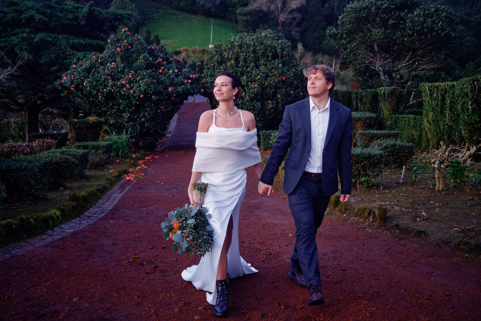 The couple walking a garden path on São Miguel