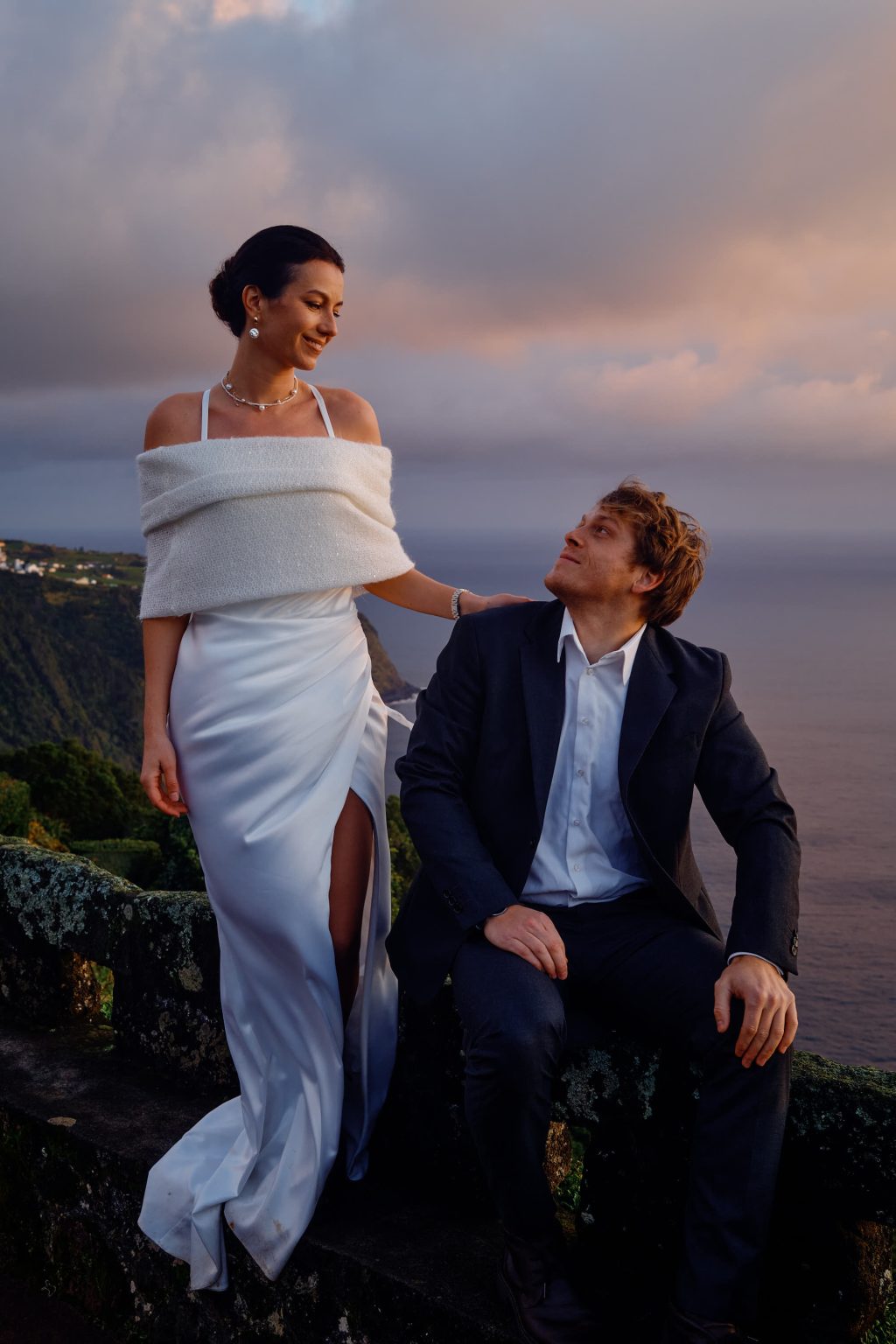 The couple sitting at a São Miguel viewpoint