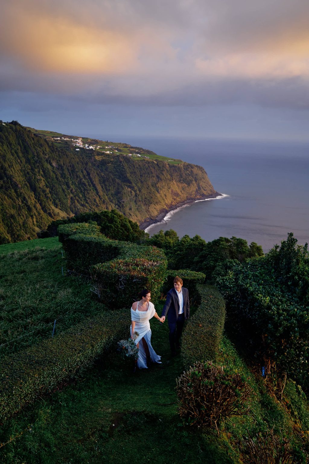 Bride and groom on the green cliffs of São Miguel