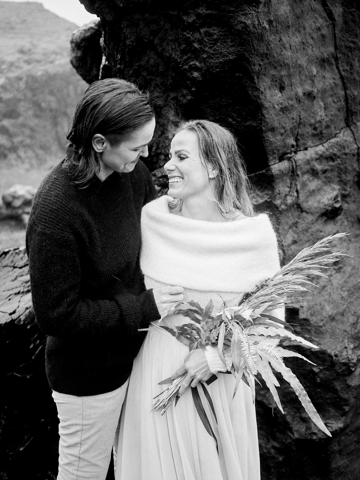 Klara Jenný and Siddy embracing on the black coast, a Snæfellsnes elopement