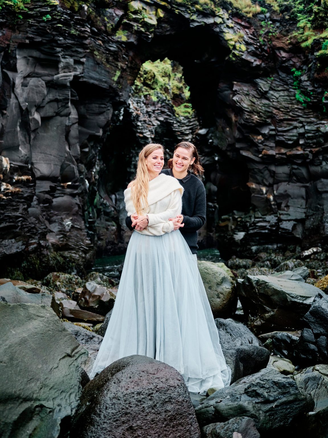 An embrace beneath a lava arch, Snæfellsnes, Iceland