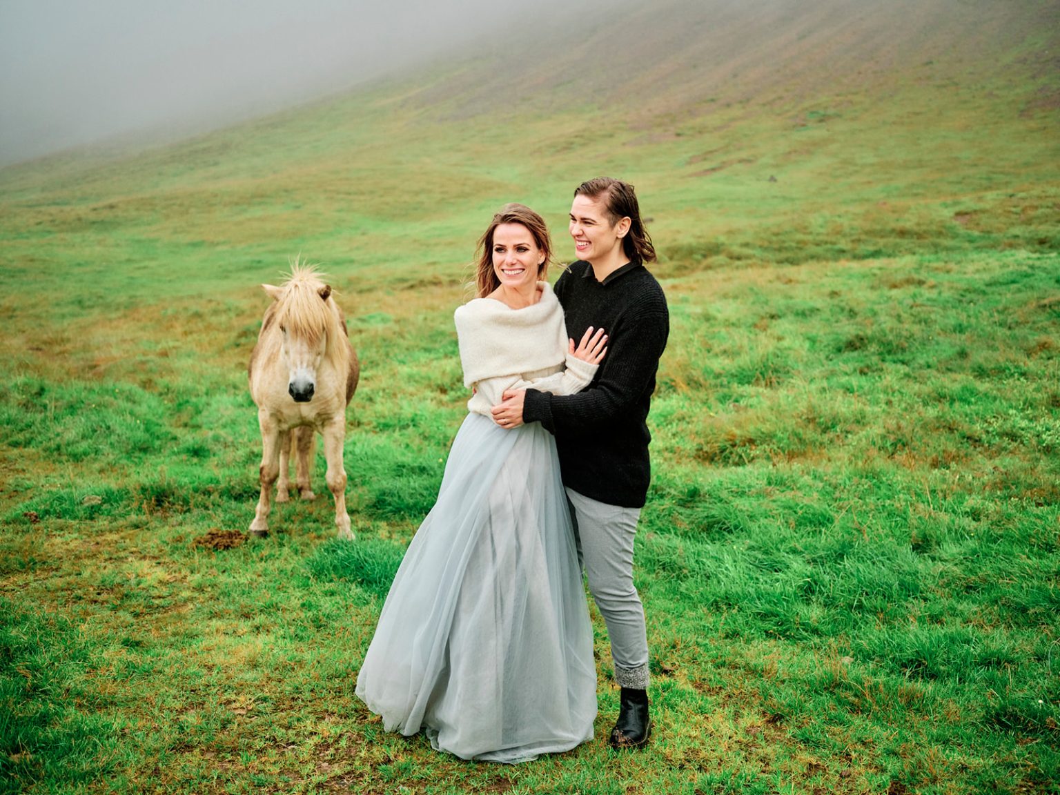 The couple with their dog in a green field, Snæfellsnes, Iceland