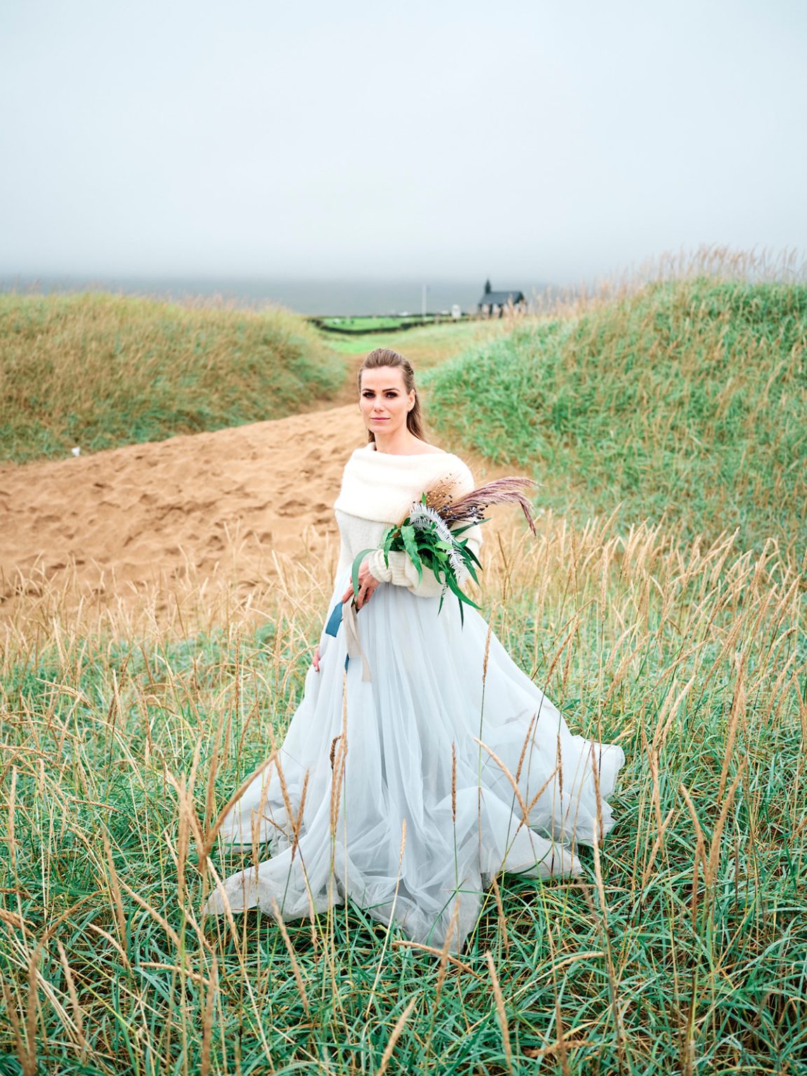 The bride with her bouquet in a green field, Snæfellsnes elopement