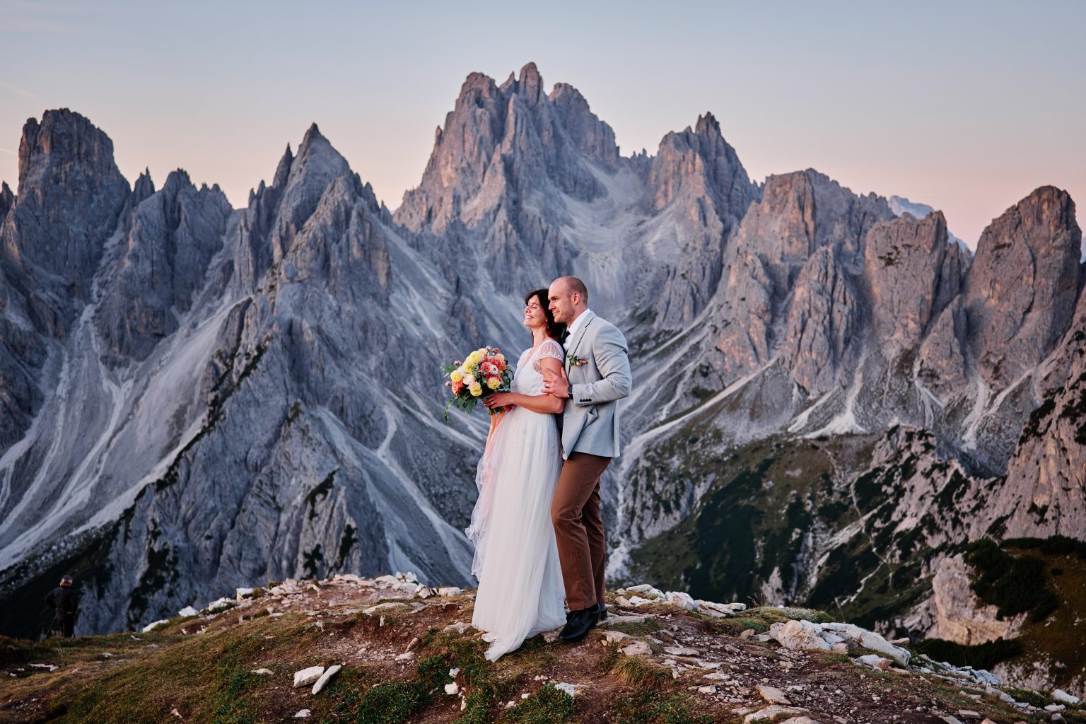 Couple before the three peaks of Tre Cime di Lavaredo, Dolomites elopement