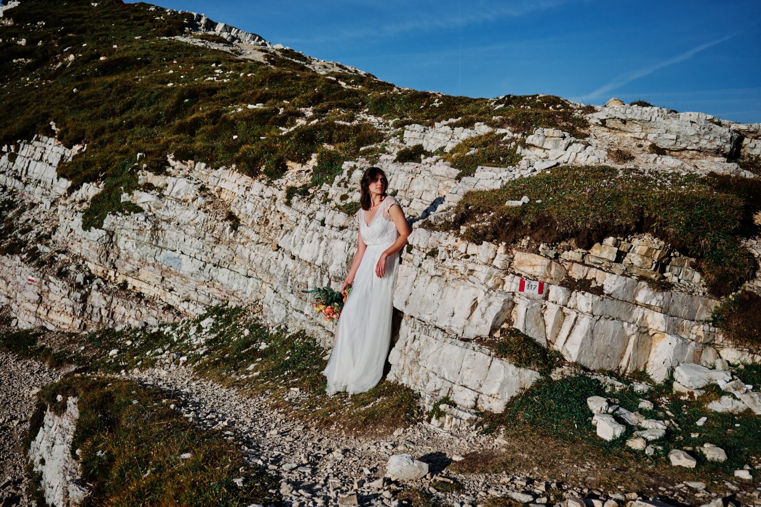Bride on the white rock ledges, Dolomites elopement