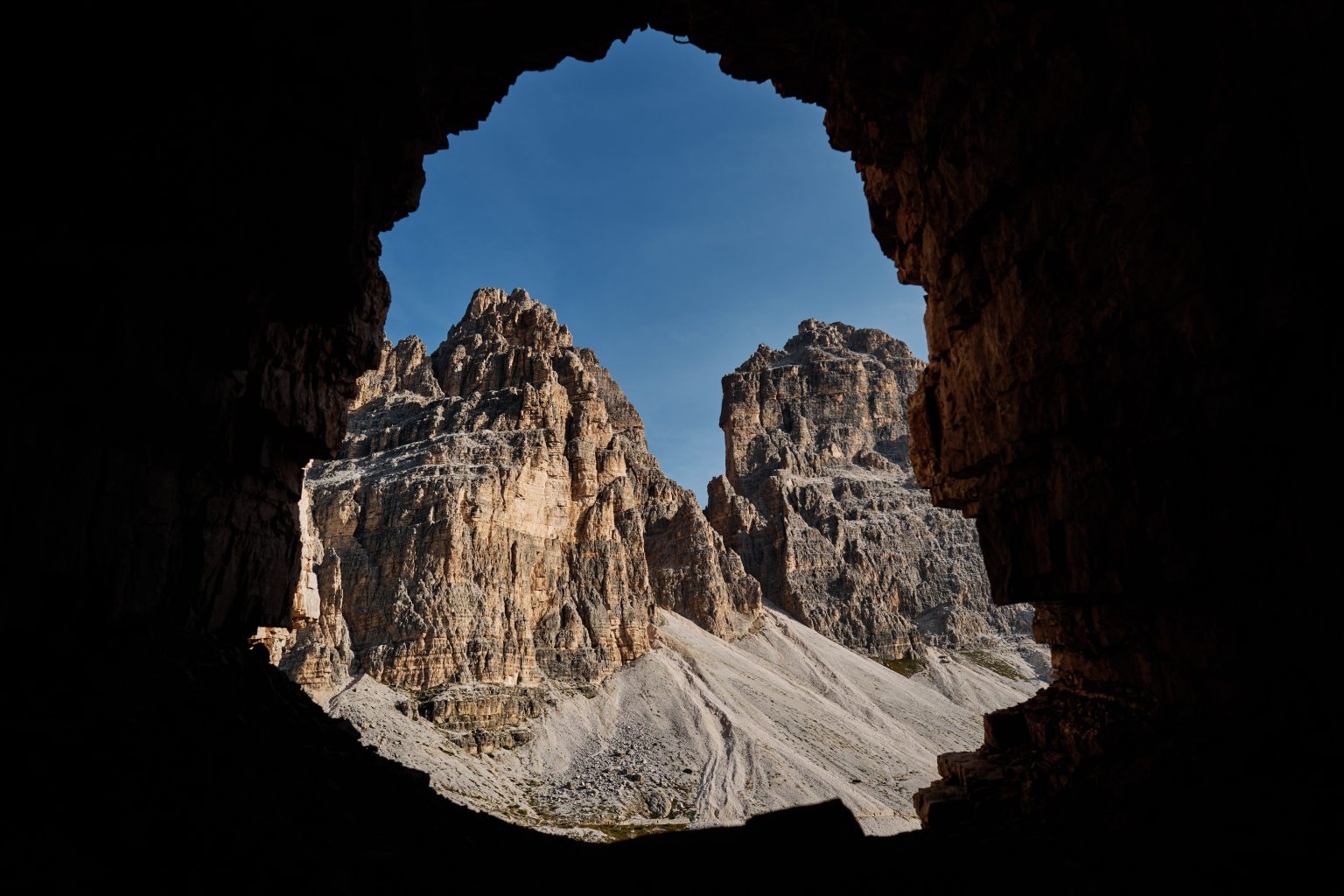 The three peaks framed through a rock arch, Tre Cime di Lavaredo
