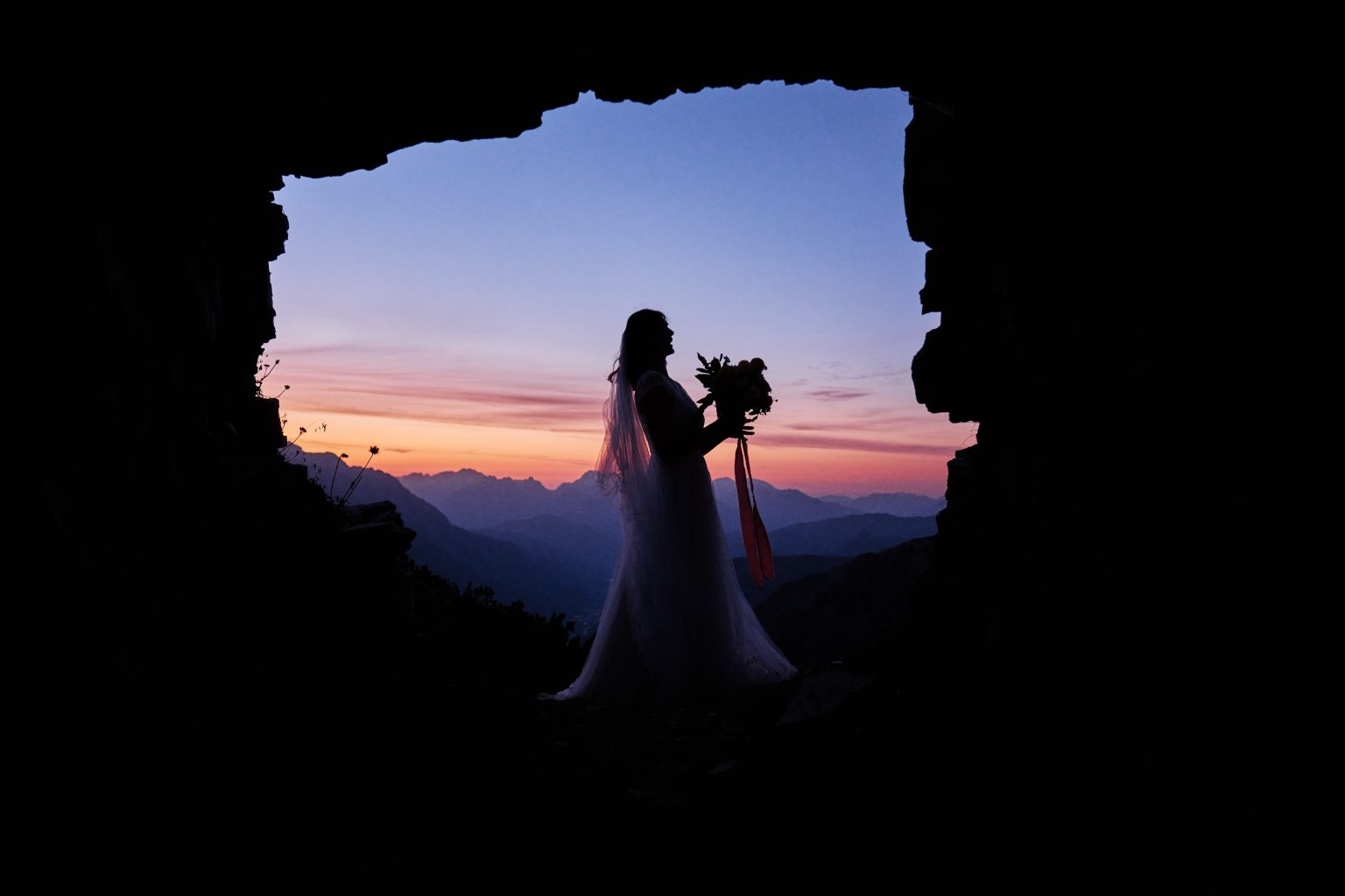Bride framed in a rock window at sunrise, Tre Cime di Lavaredo