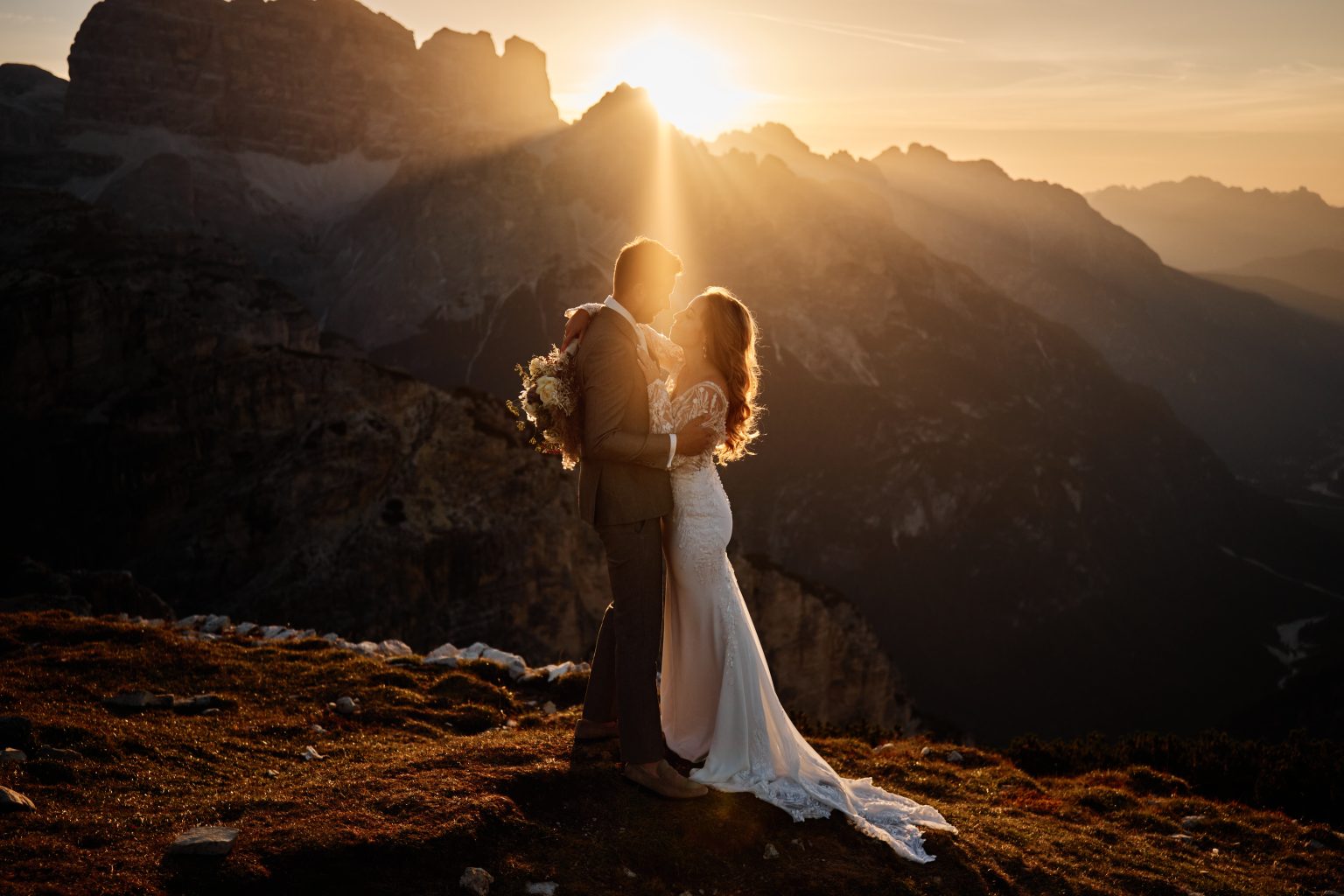 Bride against the rising sun, Tre Cime di Lavaredo wedding