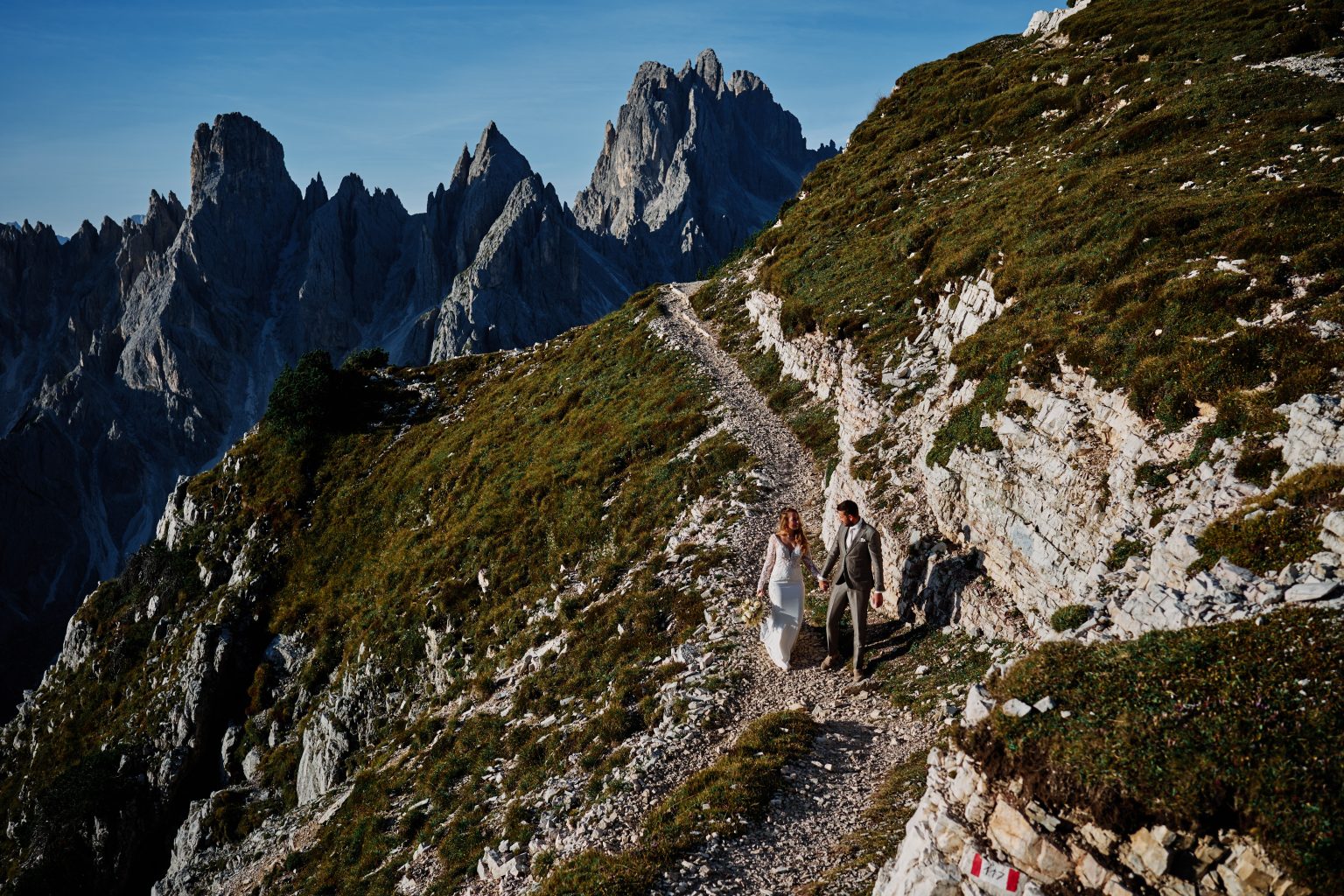 The couple on a green ridge below the peaks, Tre Cime di Lavaredo wedding