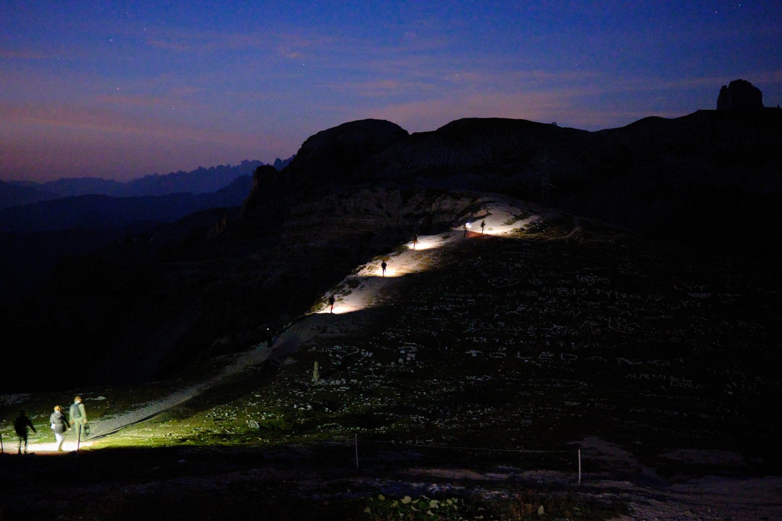 The couple hiking up in the dark before dawn, Tre Cime di Lavaredo