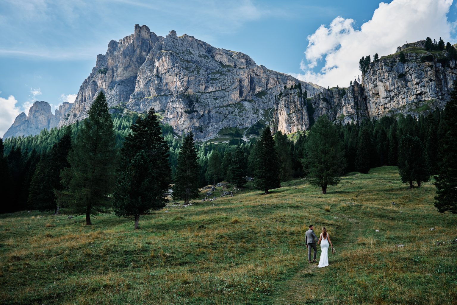 Charlotte and Collin in a green alpine meadow, Dolomites wedding