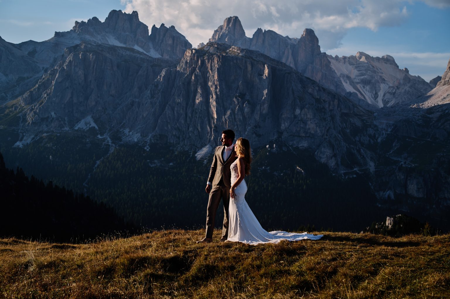 Charlotte and Collin below the layered peaks, Passo Giau